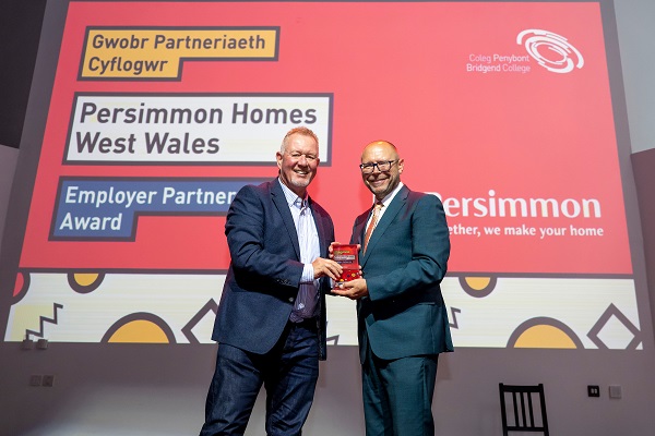 Persimmon Homes Carl Davey receiving an award from Bridgend College